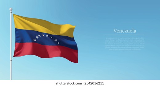 Waving flag of Venezuela on a pole with a blue sky backdrop with copyspace