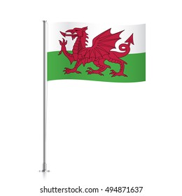 Waving flag of Wales on a metallic pole, isolated on a white background.