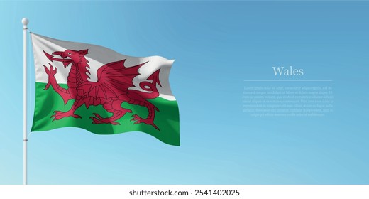 Waving flag of Wales on a pole with a blue sky backdrop with copyspace