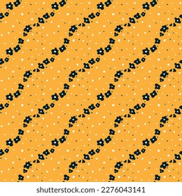 Wavy chains of small dark flowers on a yellow background. Summer wind. Seamless vector image.