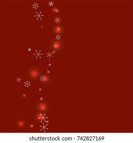 Wavy Christmas background with random scatter falling silver snowflakes and red blurred lights on a burgundy background.