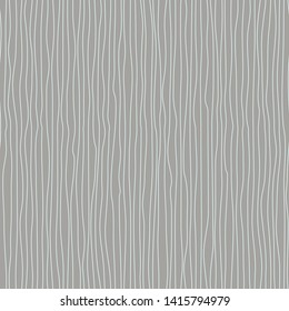 Wavy line pattern. White vertical wavy lines with a vertical direction on gray background. Strips similar to threads. Hand drawn stripes. Hand painted improvised white lines against gray color.