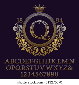 Wavy patterned gold letters and numbers with initial monogram in coat of arms form. Decorative patterned font for logo design. Isolated english vintage alphabet, figures.