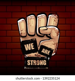 We are strong concept illustration with rised fist in the air isolated on brick wall background. Motivational slogan