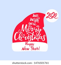 We wish you a merry Christmas and a happy New Year. Hand lettering. Santa Claus hat.