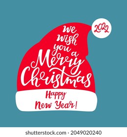 We wish you a merry Christmas and a happy New Year. Hand lettering. Santa Claus hat.