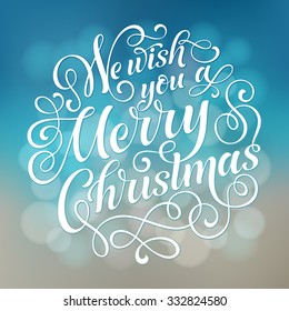 We wish you a Merry Christmas vector text on defocus background. Holidays lettering for invitation, greeting card, prints and posters. Hand drawn typographic inscription, christmas calligraphic design