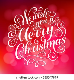 We wish you a Merry Christmas vector text on defocus background. Holidays lettering for invitation, greeting card, prints and posters. Hand drawn typographic inscription, christmas calligraphic design