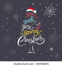 'We wish you a Merry Christmas' hand drawn lettering over cute christmas tree decoration element vector illustration. Perfect design for greeting cards.