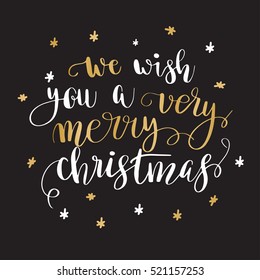 We wish you a very merry Christmas. Greeting card with calligraphy. Handwritten modern brush lettering. White and gold quote on black background