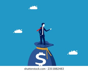 Wealth. Businessman standing on a big money bag.