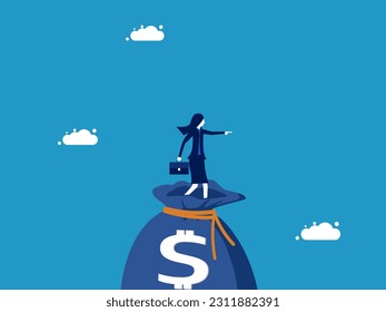 Wealth creation and investment advancement. Businesswoman standing pointing to a large money bag