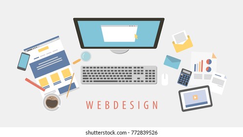 Web design desk top view with computer, notebook and more.