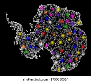 Web mesh vector map of Antarctica with glare effect on a black background. Abstract lines, light spots and points form map of Antarctica constellation.