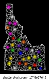 Web mesh vector map of Idaho State with glare effect on a black background. Abstract lines, light spots and spheric points form map of Idaho State constellation.