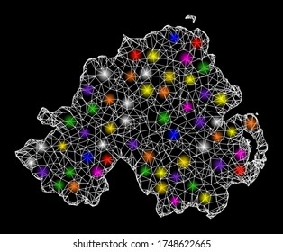 Web mesh vector map of Northern Ireland with glare effect on a black background. Abstract lines, light spots and dots form map of Northern Ireland constellation.