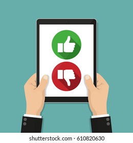Website rating feedback and review concept. Hand holding tablet with like and dislike