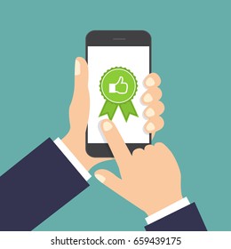 Website rating feedback and review concept. Hand holding and pointing to a smartphone with like