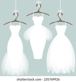 Wedding dresses on hangers. Pastel background