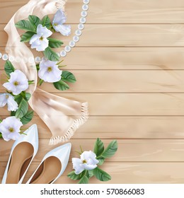 Wedding Floral Top View Background With White Flowers, Shoes, Silk Scarf, Pearl Beads On A Wooden Table