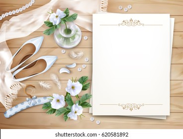 Wedding floral top view background with white flowers, blank paper sheet, shoes, feathers, silk scarf, pearl beads on a wooden floor