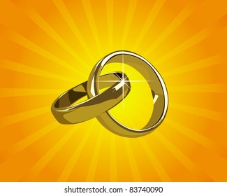 wedding gold rings on a background of orange light