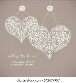 Wedding invitation decorated with white lace hearts 