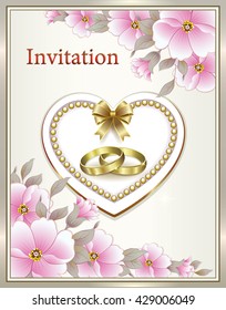 Wedding invitation with flowers and rings in a frame