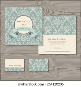 Wedding invitation, save the date cards, place card. Wedding set on a wooden background. 
