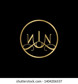 Wedding logo monogram with two curly letters mirrored. Initial gold letter n nn inside circle vector logo design template on black background. Suitable for wedding invitation, tailor shop, print, web.