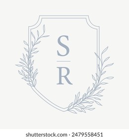 Wedding monogram crest design with SR initial surrounded by floral elements