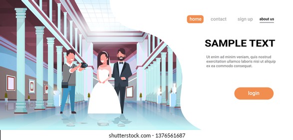 wedding photographer shooting on camera newlyweds man woman standing together romantic couple bride and groom embracing man taking professional photo museum hall interior horizontal copy space