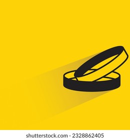 wedding ring with shadow on yellow background