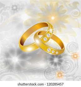 Wedding rings on the floral background
