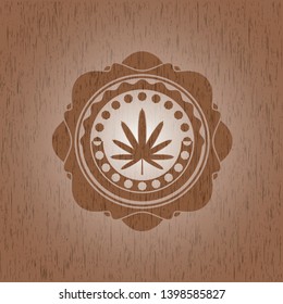 weed leaf icon inside badge with wood background