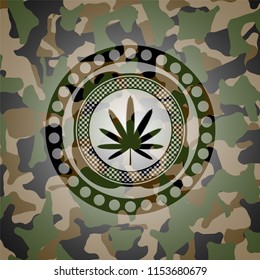 weed leaf icon inside camouflage emblem