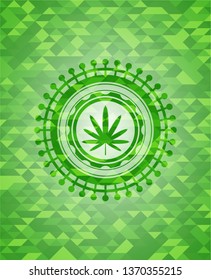 weed leaf icon inside green emblem with mosaic background