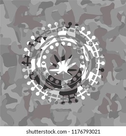 weed leaf icon inside grey camouflaged emblem