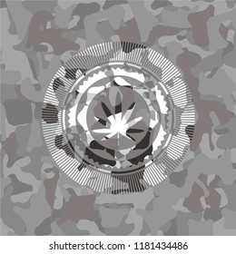 weed leaf icon inside grey camouflage emblem