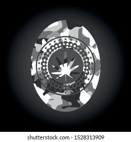 weed leaf icon inside grey camouflage emblem