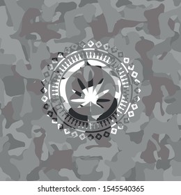 weed leaf icon inside grey camouflage texture
