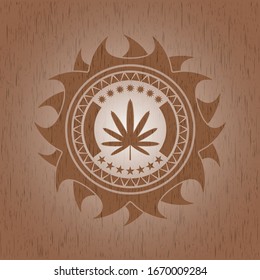 weed leaf icon inside realistic wooden emblem