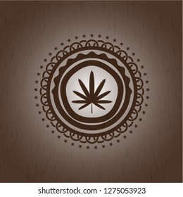 weed leaf icon inside retro wooden emblem