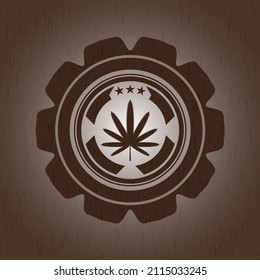 weed leaf icon inside vintage wood emblem. 