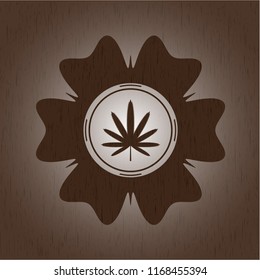weed leaf icon inside wood badge or emblem