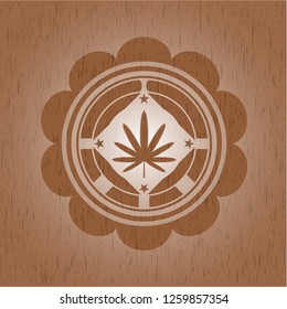 weed leaf icon inside wood badge or emblem