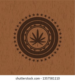 weed leaf icon inside wood emblem