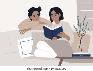 Weekend leisure activities, a couple reading a book together in the living room, cozy domestic life during the lockdown