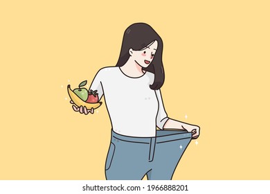 Weight loss and diet concept. Happy smiling woman in oversized jeans standing holding fresh fruits and vegetables showing weight loss results vector illustration 