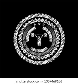 weightlifter girl icon inside chalkboard emblem written on a blackboard